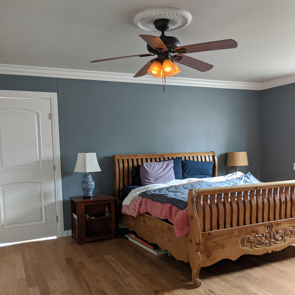 Professional interior painting by Paint Daddy in Santa Clarita, featuring crisp white vaulted ceilings, dark accent walls, and precision trim work in a master bedroom.