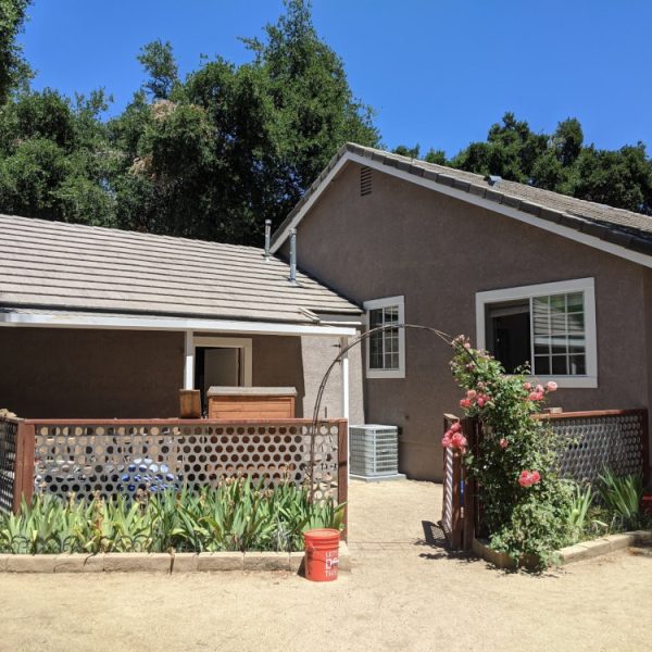 Full view of a residential exterior repaint in Saugus, CA, with stucco and trim finishes completed by second-generation painter Paint Daddy.