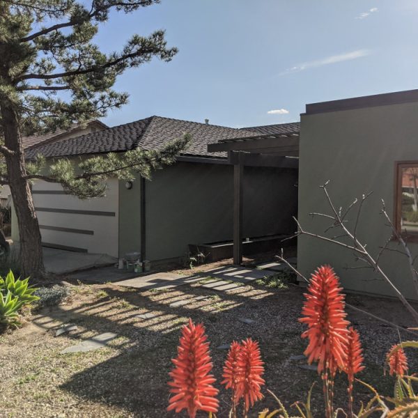 Full view of a mountain home in Lebec, CA, featuring freshly painted green stucco by Paint Daddy.
