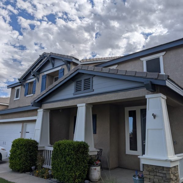 The finished high-end front entryway of a Santa Clarita home, featuring a freshly painted crisp white contrast on the architectural trim and ceiling, while the stucco remains original, completed by Paint Daddy.