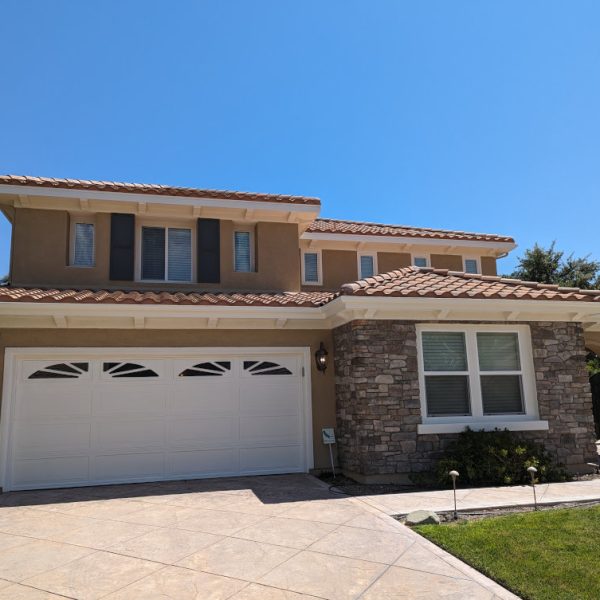 Full view of a complete high-end residential exterior repaint in Santa Clarita, featuring new two-tone stucco finishes and contrasting trim, completed by Paint Daddy.