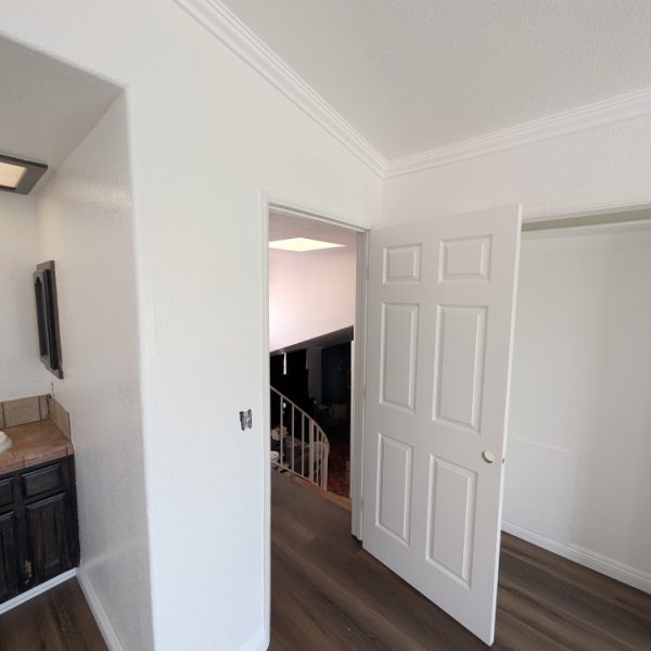 Freshly painted white interior featuring crisp crown molding, door casings, and baseboards in a Santa Clarita home, completed by Paint Daddy.