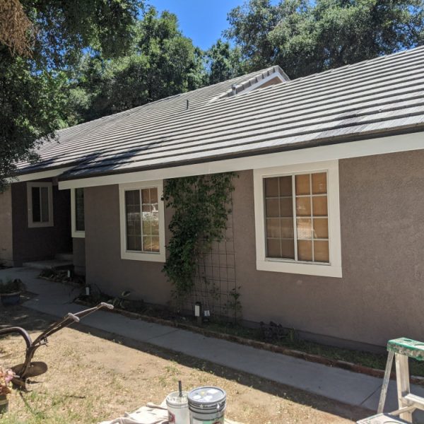 Residential exterior repaint in Saugus, CA, with grey stucco and white trim by Paint Daddy.