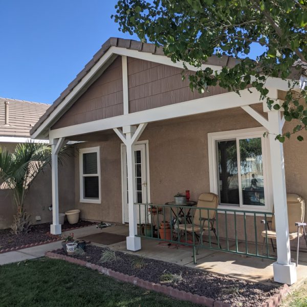 A front porch view featuring sandy tan stucco, cocoa brown horizontal gable siding, and brilliant white support posts and trim by Paint Daddy.